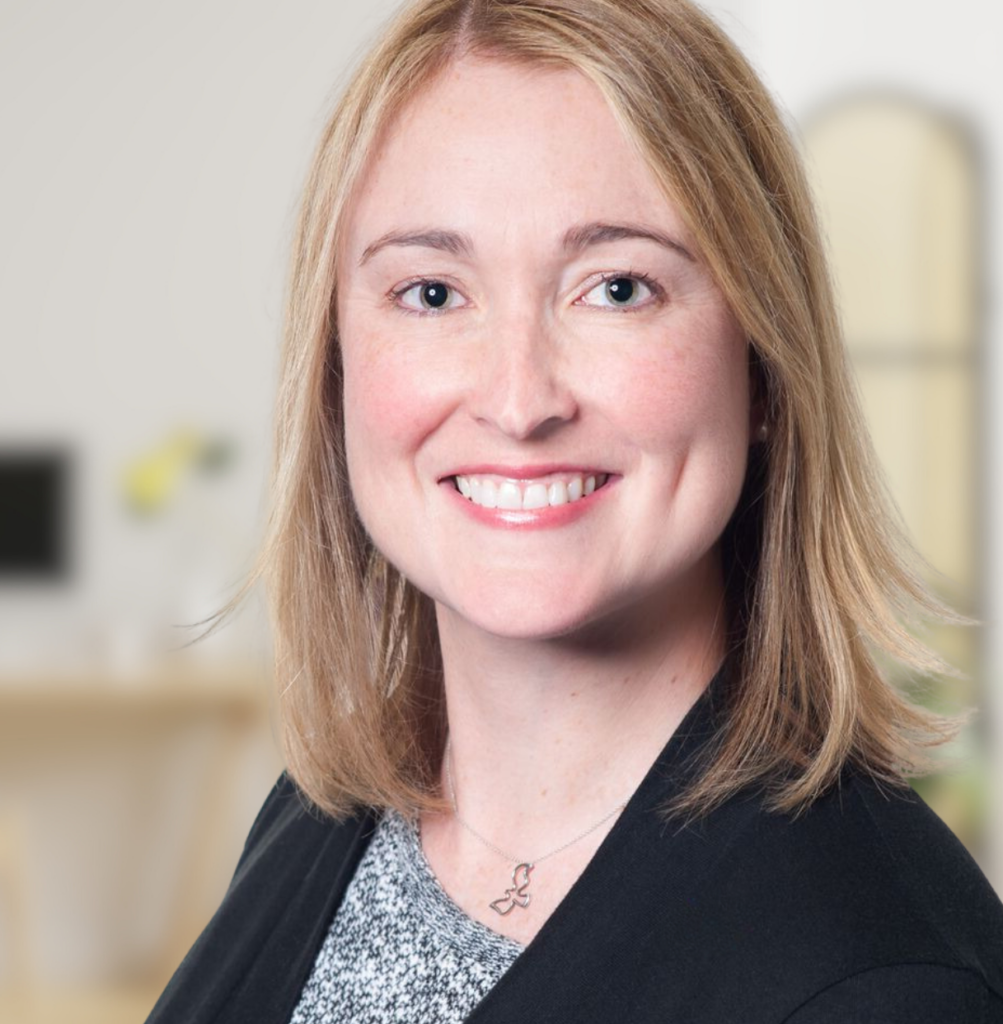 Profile photo of Monica, who is a white woman with blonde hair. She is wearing a dark blazer.